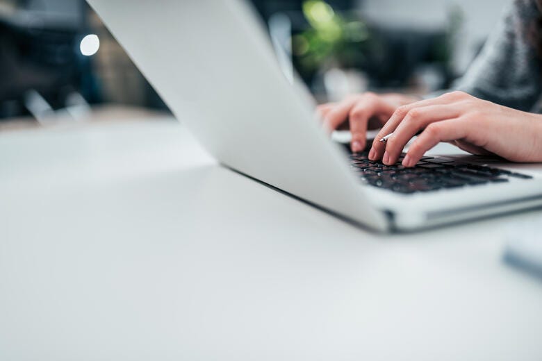 a person typing on a laptop